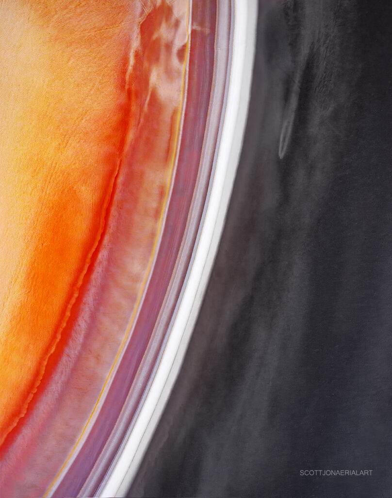 Curving bands of colour at a mine tailings dam from the air, Western Australia