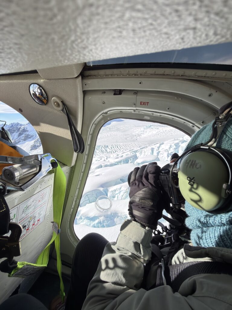 Shooting the glacier icefall from the open door of a helicopter