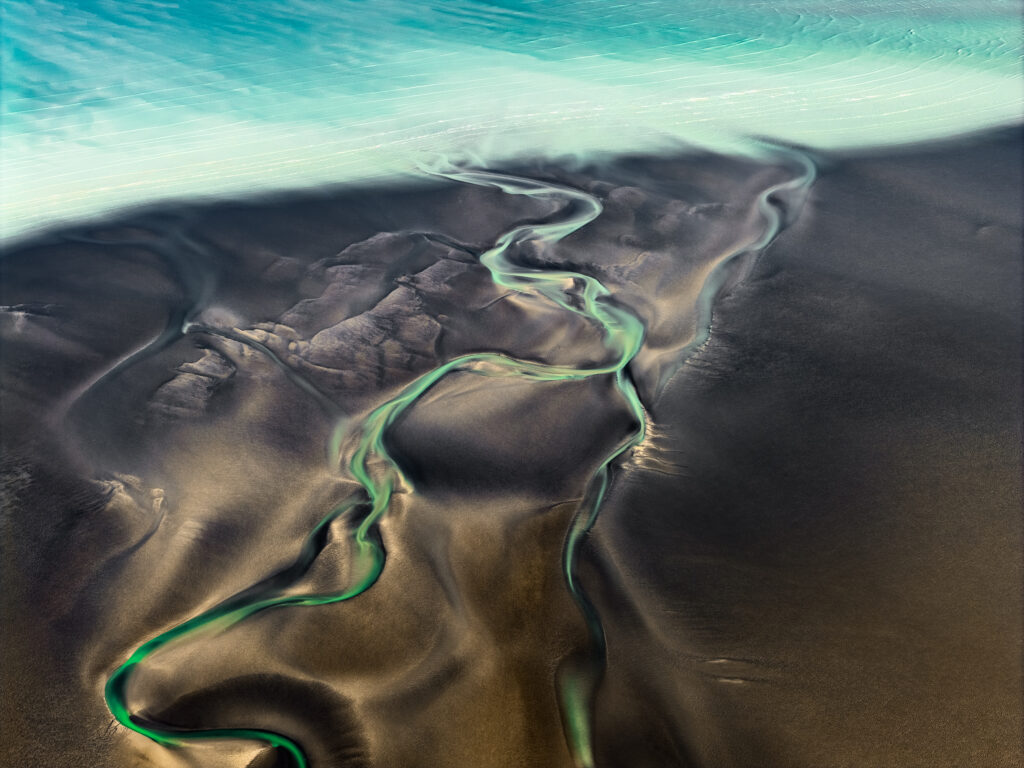 Turquoise water and winding green tidal channels across Kimberley mudflats near Broome, aerial photograph by Scott Jon